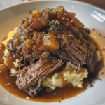 Slow-Cooked Pot Roast with Gravy Over Creamy Mashed Potatoes