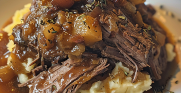 Slow-Cooked Pot Roast with Gravy Over Creamy Mashed Potatoes