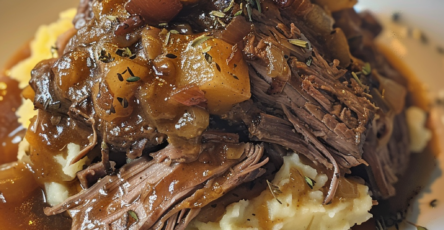 Slow-Cooked Pot Roast with Gravy Over Creamy Mashed Potatoes